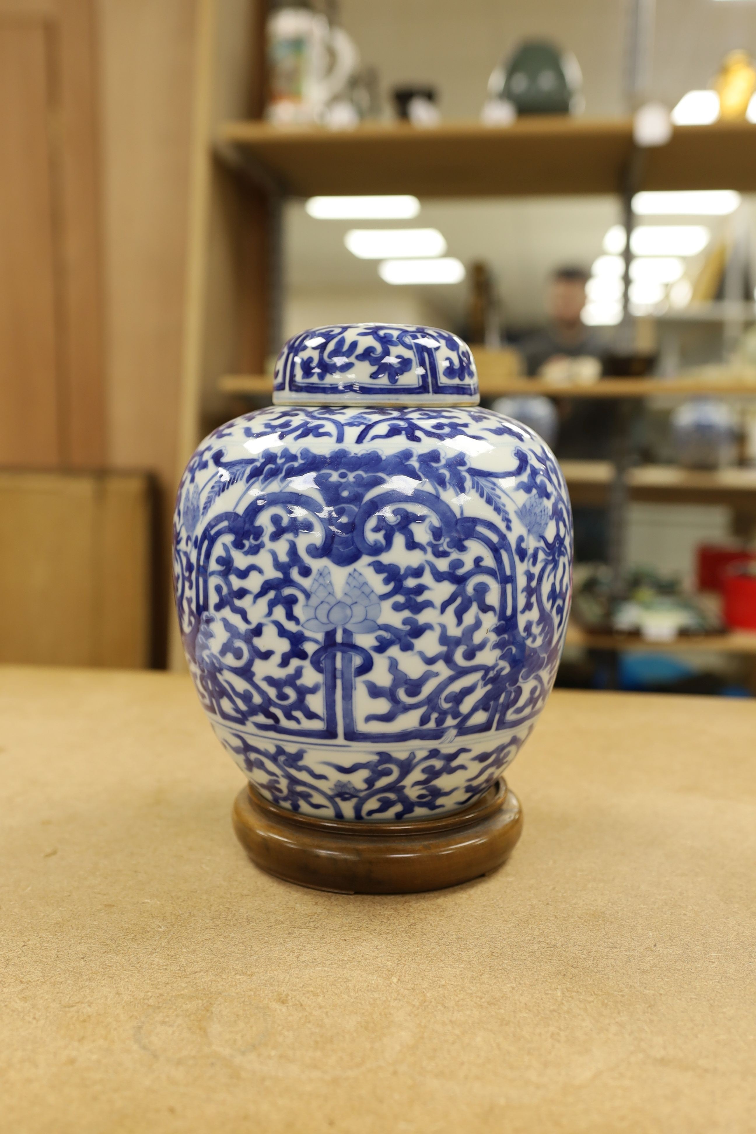 A pair of Chinese blue and white ginger jars and covers, 22cm, On stands